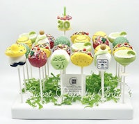 a display of cake pops with a variety of toppings